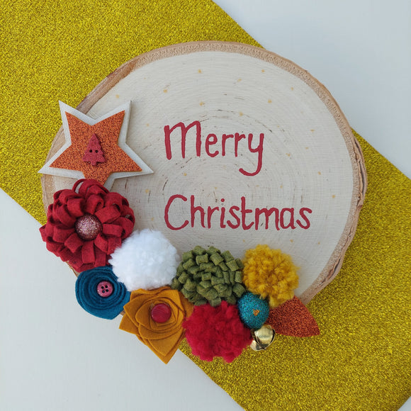 Decorative Christmas card with colorful flowers and 'Merry Christmas' text on a gold background.